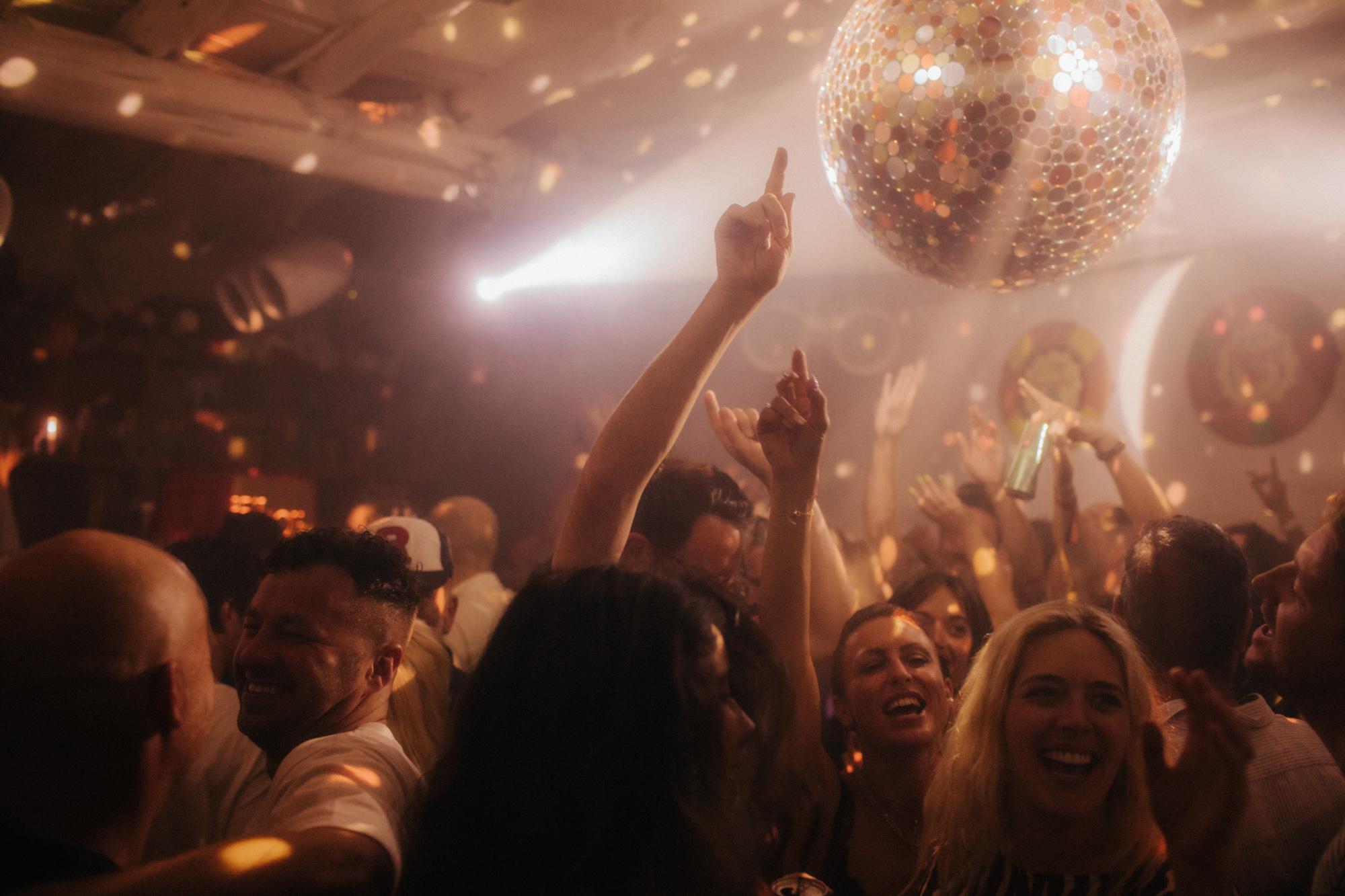 Crowd dancing under a disco ball at Beat Hotel